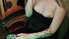 Mistress smokes a cigarette while commanding attention in her dark lair.