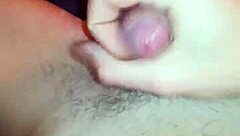 She moans as I massage her wet pussy and stroke my cock until creampie