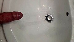 Guy pisses with a hard cock