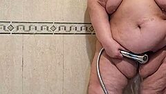 Intriguing mature woman pees and gets fucked by her dildo