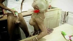 a blonde woman plays with cream and her man's food in the kitchen