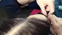 brunette babe clamps her nipples in close up view