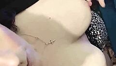 brunette babe clamps her nipples in close up view