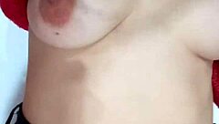 Playing with a belt, spanking my natural tits hard.