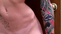 A tattooed woman enjoys solo time in the bathroom, exploring her body with gentle touches.