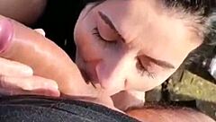 She sucks his cock roadside.