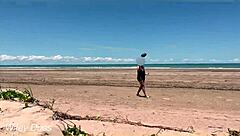 Watch my wife play football nude on the public clothed beach? She's flashing her big tits!