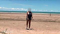 Watch my wife play football nude on the public clothed beach? She's flashing her big tits!