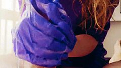 in a quiet room, a redhead works a huge cock with gloved hands, ending in a cum-covered mess.