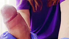 in a quiet room, a redhead works a huge cock with gloved hands, ending in a cum-covered mess.