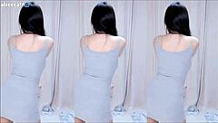 Asian girl with big tits and cute Korean style dances wildly to reveal sexy boobs in short skirt