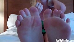 Lesbian foot fetish involves licking toes and delivering footjobs with jerk instructions.
