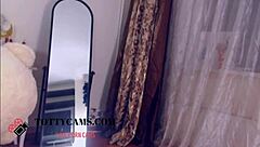 The narrative follows a dark-haired European woman appearing solo on camera in an amateur setting