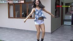 Mexican teen shakes her ass in booty shorts, seducing with bold dance moves.