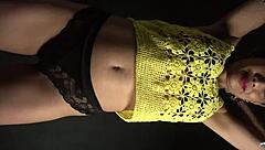 Moving her butt and hips to the music in a sexy outfit with long nails