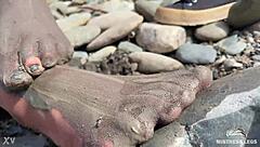 Goddess flaunts filthy nylon feet in torn pantyhose by river