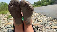Goddess flaunts filthy nylon feet in torn pantyhose by river