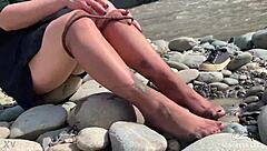 Goddess flaunts filthy nylon feet in torn pantyhose by river