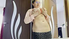 in a quiet room, a tattooed blonde with big tits fingers her pussy while masturbating passionately