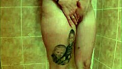 Intense squirting housewife with pierced nipples goes wild in amateur shower close-up action