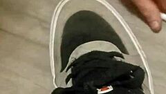 Why is my friend having so much fun trashing my sneakers? Provocative foot fetish scene.