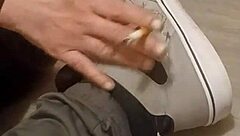 Why is my friend having so much fun trashing my sneakers? Provocative foot fetish scene.