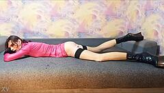 Ponygirl crossdresser relaxes on the couch.