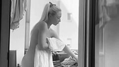 Naked chubby woman hangs laundry on balcony for neighbors to watch