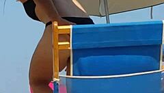 Hey, check this candid bikini slut at the beach 😏