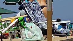 Hey, check this candid bikini slut at the beach 😏