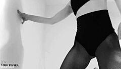 this brunette babe teases in fishnet tights, showing off her ass and feet. she poses in black and white for an interracial fetish vibe.