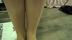 Girl having fun popping balloons while wearing sheer pantyhose in a playful session. 🎈😊