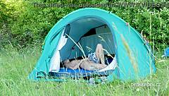 Nudist milf relaxes fully exposed on beach in outdoor tent setting