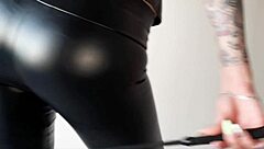 dominatrix in tight leggings demands ass worship from her slave, teasing with face sitting and juicy curves in this femdom fetish scene.