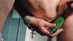 Hey, watch this German granny stuffing her hairy beaver with a cucumber for fun