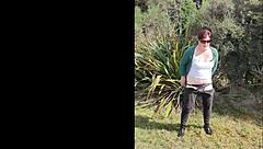 Narrative of trashy Kiwi milf pissing on roadside amid traffic in outdoor public scene