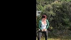 Narrative of trashy Kiwi milf pissing on roadside amid traffic in outdoor public scene