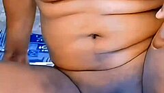 This athletic ebony shemale with a small cock strips down at home, teasing in see-through clothes before riding a dildo.