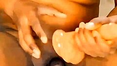 This athletic ebony shemale with a small cock strips down at home, teasing in see-through clothes before riding a dildo.