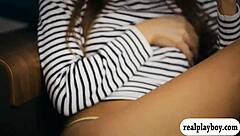 a sexy brunette babe fingers her shaved pussy moaning hard in solo play on the bed