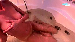 Petite babe in bikini plays with wet pussy in the bathroom