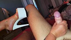 Woman in high heels poses seductively on bed with boots