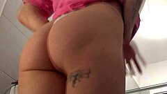 A cute redhead strips in the bathroom showing off her figure and curves